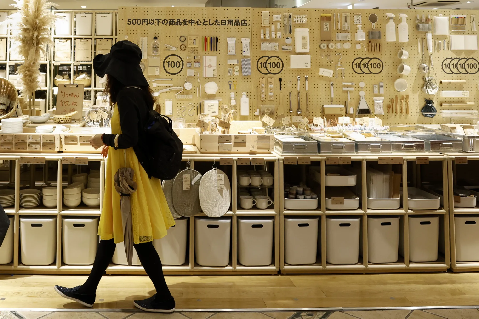 A customer in front of household products at a Muji store in Tokyo Metropolis, Japan.