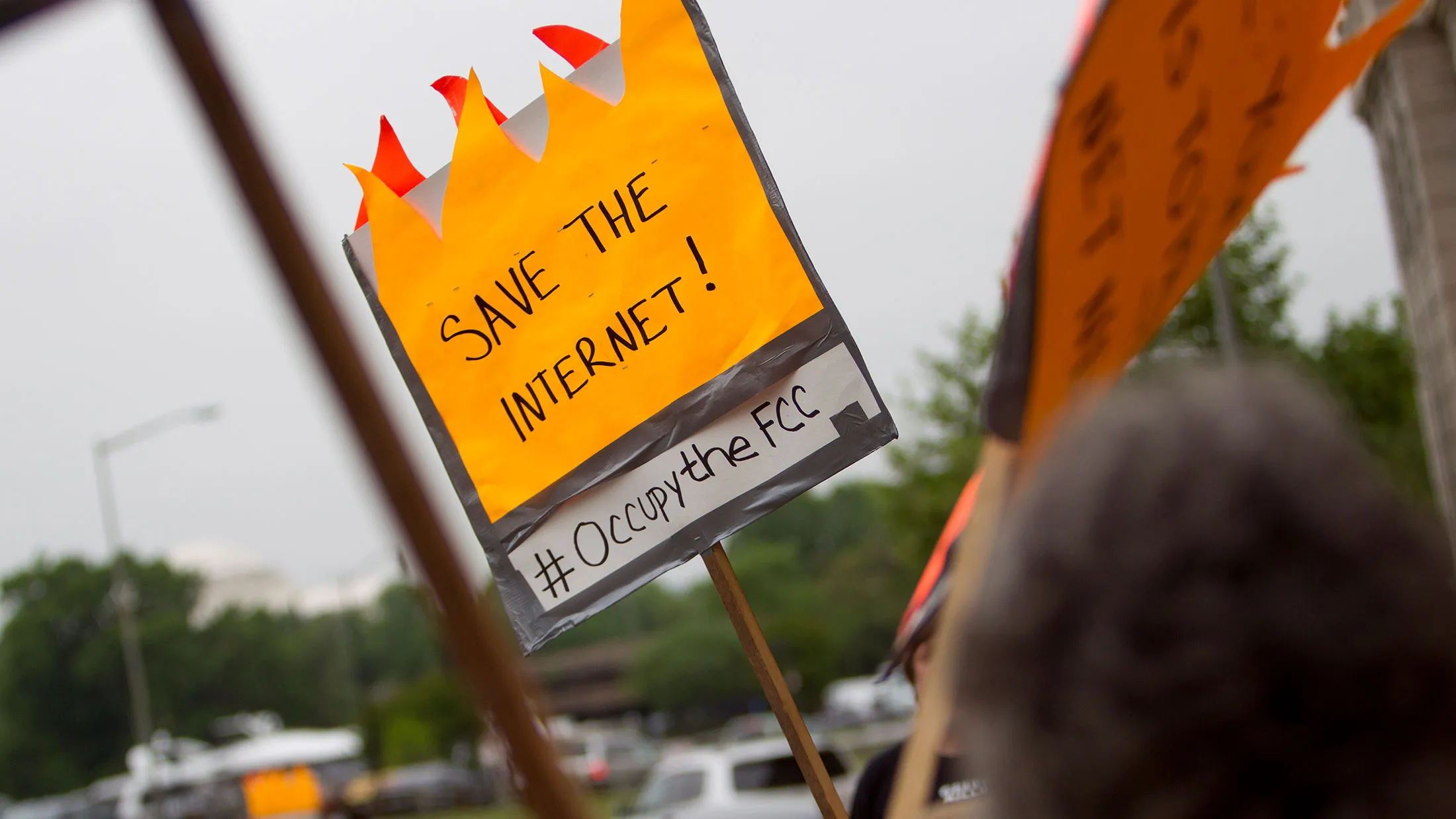 Demonstrators hold signs in support of net neutrality outside Federal Communications Commission headquarters in Washington on May 14, 2014.
