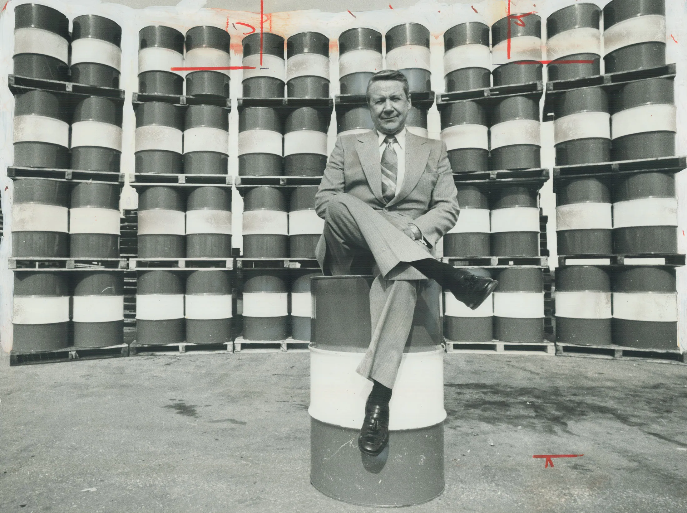 John Armstrong, chairman of Imperial Oil, perches on a&nbsp;barrel of crude oil&nbsp;with 48 more arrayed behind him, on April 20, 1977. Imperial Oil estimated that every Canadian man, woman and child consumed on average each year the energy equivalent of these 49 barrels of crude oil.