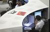 Tokyo Stock Exchange and Stock Boards As Japan Shares Dip With Banks As Volatility Returns to Markets