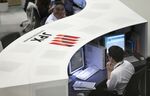 Tokyo Stock Exchange and Stock Boards As Japan Shares Dip With Banks As Volatility Returns to Markets