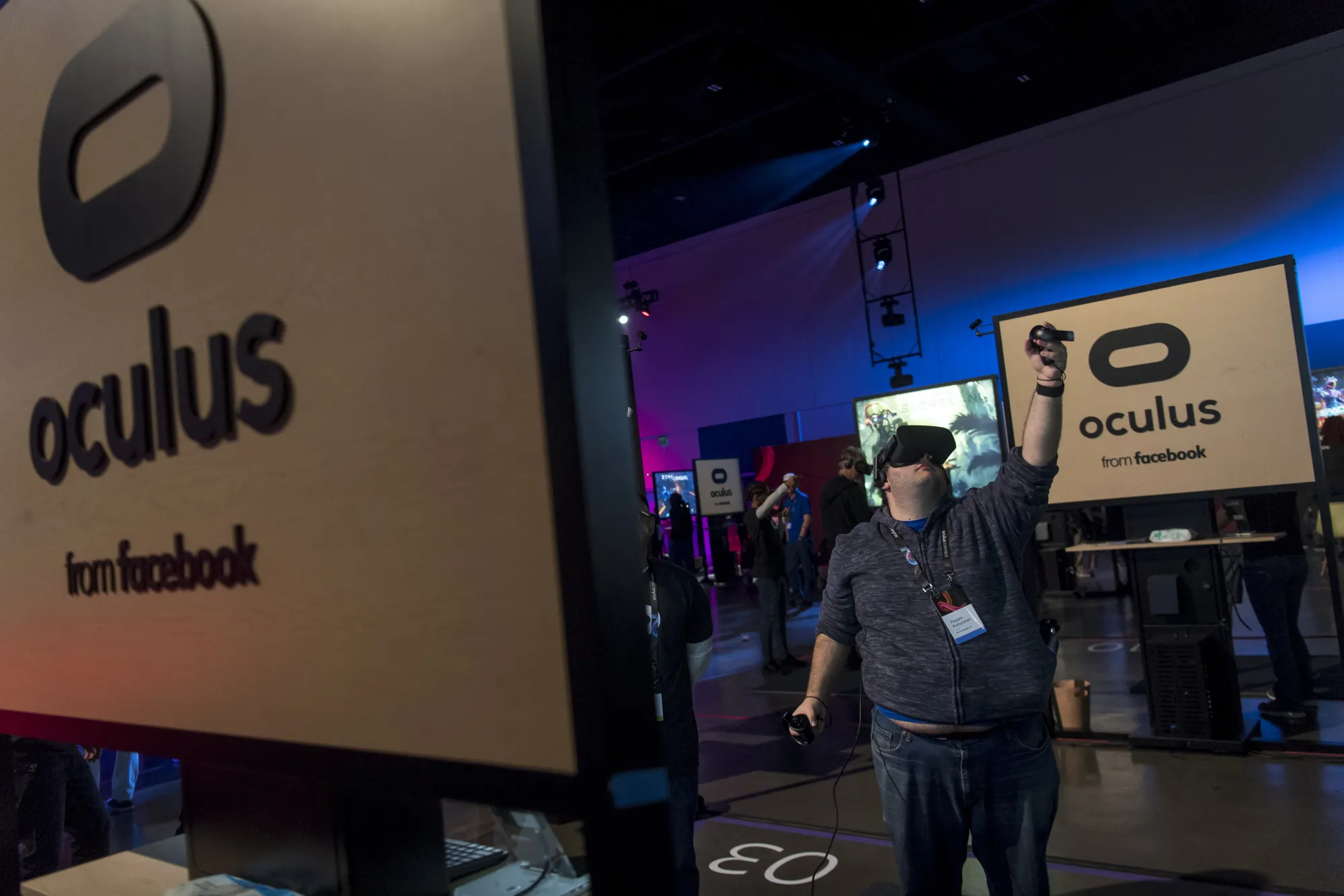 An attendee uses the Oculus VR Inc. Rift virtual reality (VR) headset and controllers.