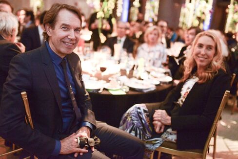 Jeff Koons with long hair and taped fingers strained from snowboarding, and Lisa Phillips, director of the New Museum.