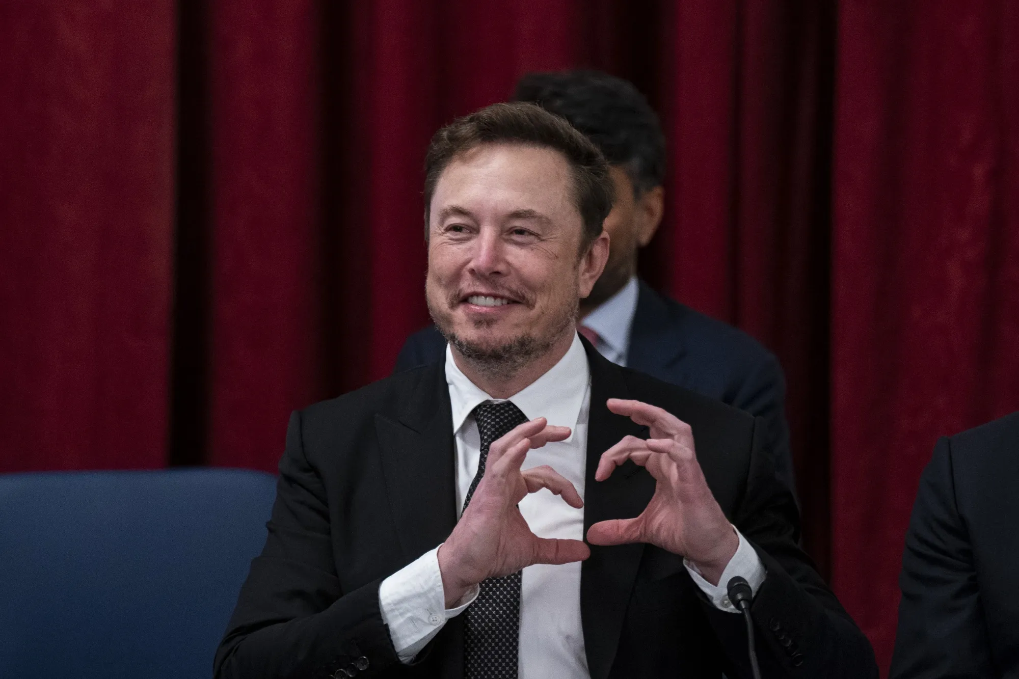 Tesla CEO Elon Musk making&nbsp;a heart with his hands during an artificial intelligence forum last year on Capitol Hill.