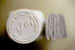 An Eli Lilly & Co. logo is seen on the cap of a pill bottle at a pharmacy in Princeton, Illinois.