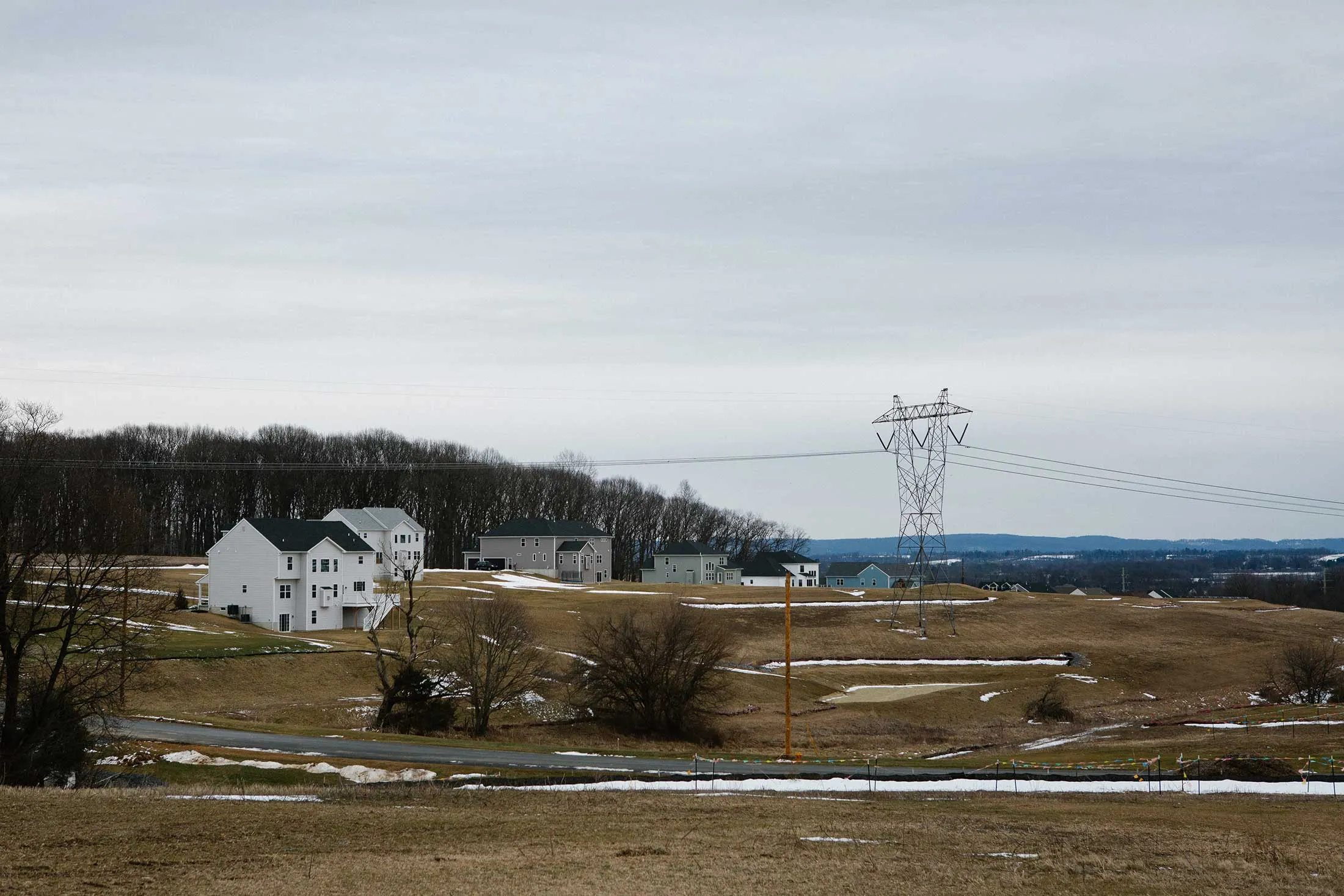 Power lines are seen within a newer housing development outside Slatington, Pennsylvania on Thursday, February 26, 2026. The rising costs of energy and utility bills, particularly in the Lehigh Valley, could become central for voters in the upcoming midterm elections. 