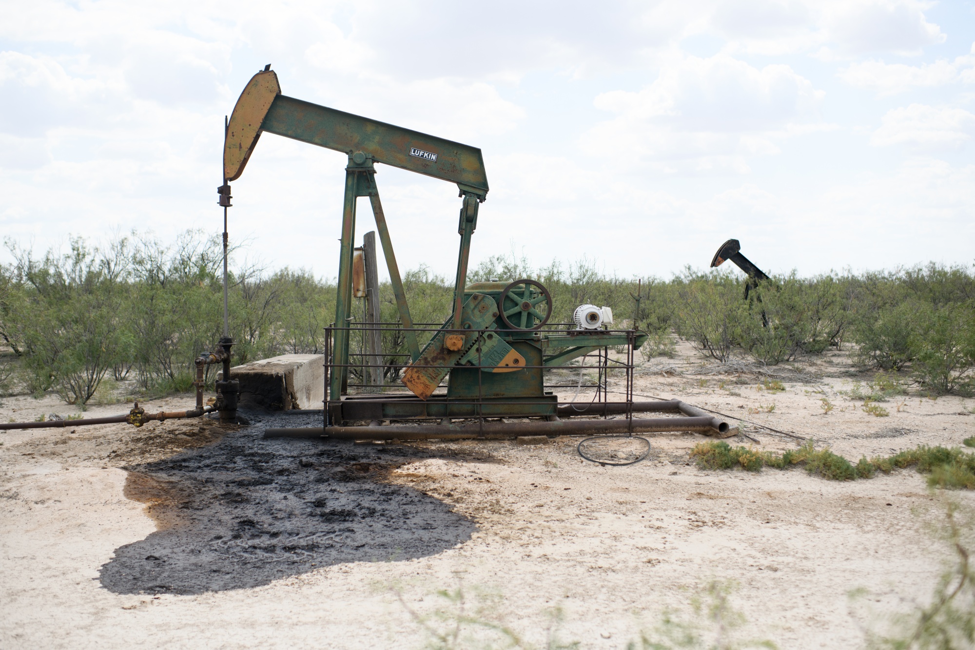 Oil seeps into the ground from an abandoned leaky well near Imperial, Texas. Photographer: Mark Felix/Bloomberg