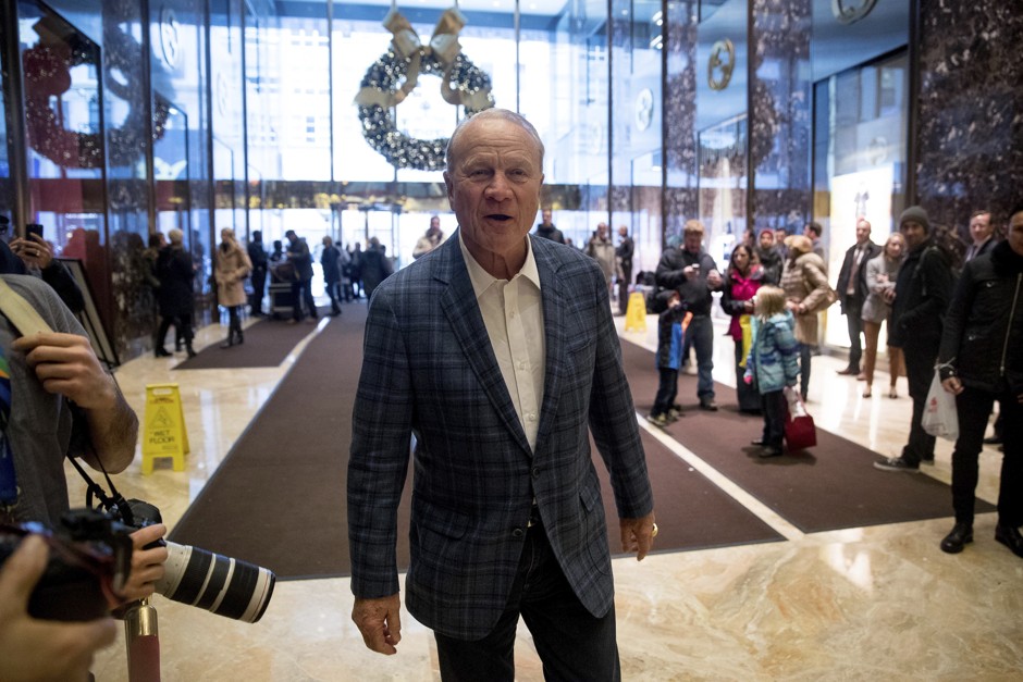 Former football player and coach Barry Switzer speaks to members of the media in the lobby of Trump Tower in New York.