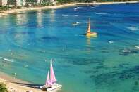 Waikiki Beach and Diamond Head with beach front hotels and catamarans on Oahu Island in Hawaii