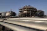 Workers repair tank structures at Saudi Aramco’s Abqaiq crude oil processing plant on Sept. 20.