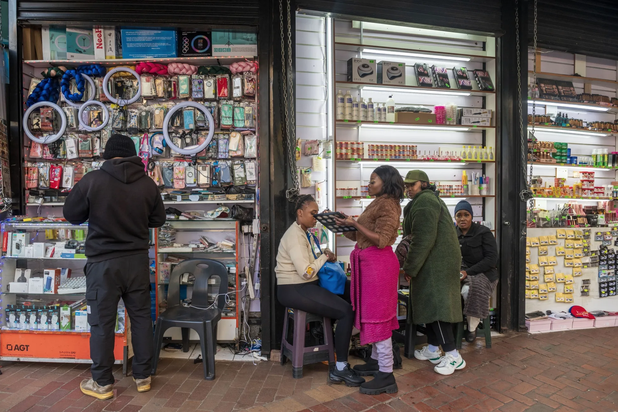 Vendors wait for customers outside stores in Johannesburg.