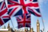 Union Jack flags in front of the Houses of Parliament.