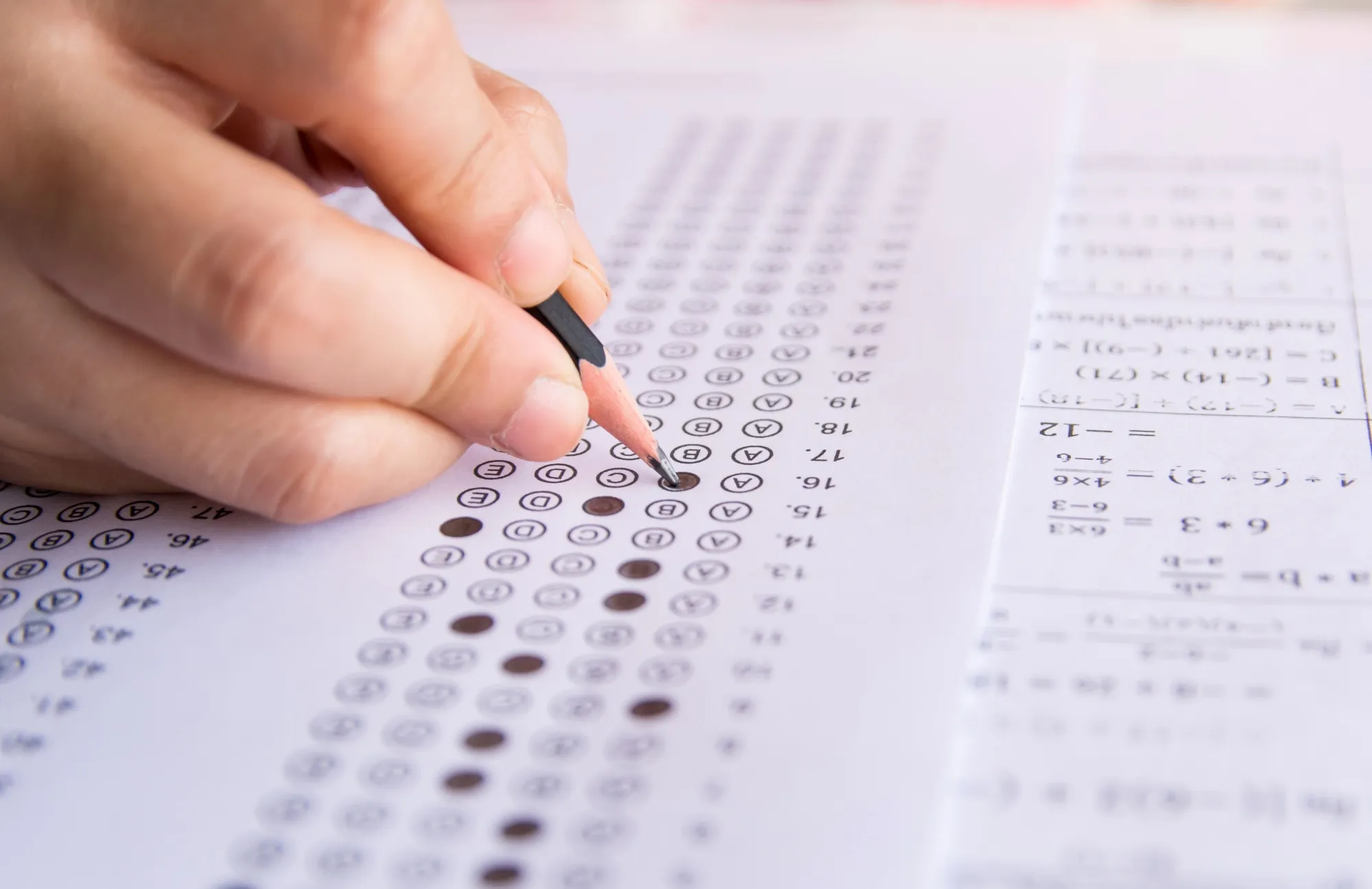 Childs Hand Filling In Multi-Answer Test With Pencil