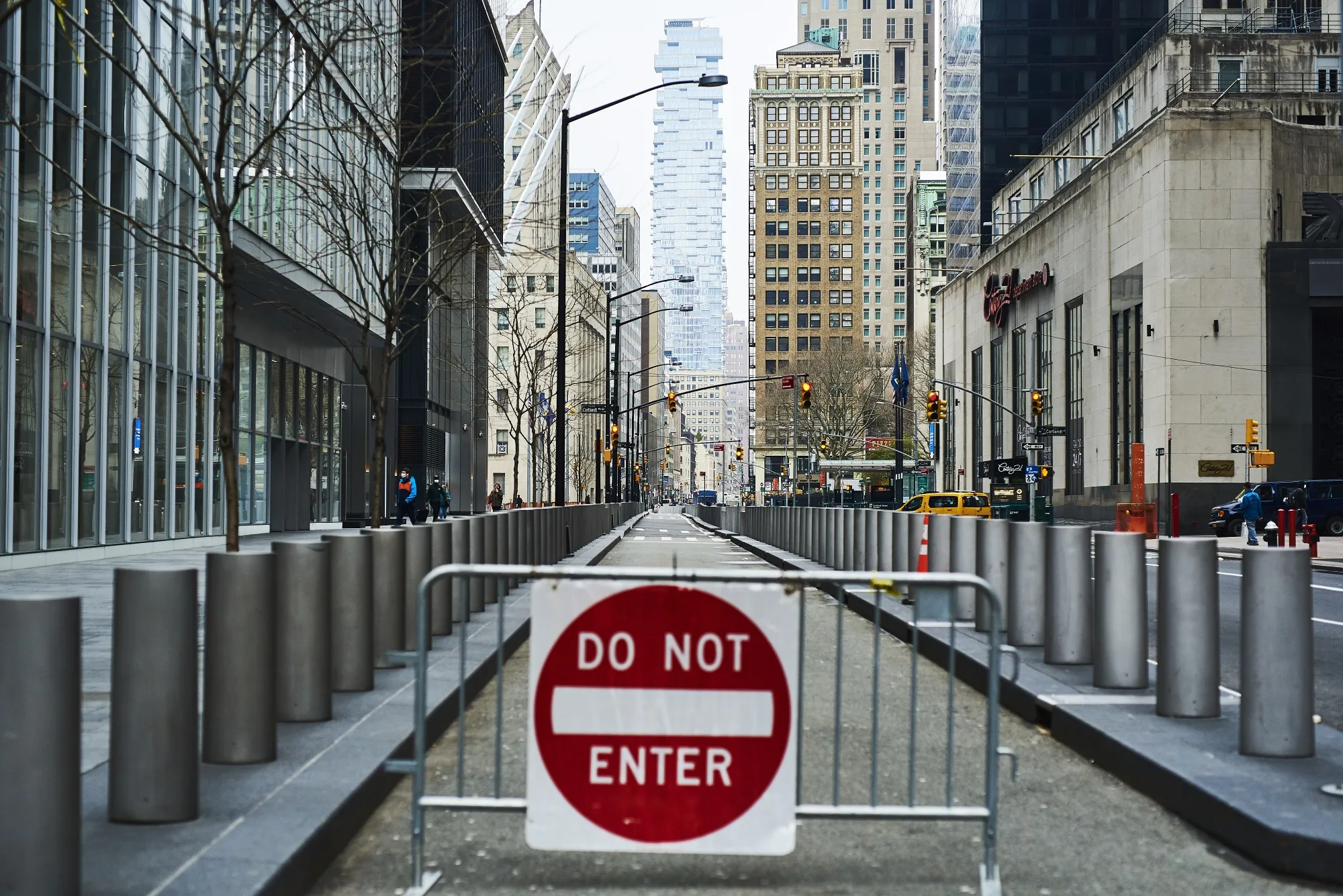A "Do Not Enter" sign stands across a street in the Financial District of New York.