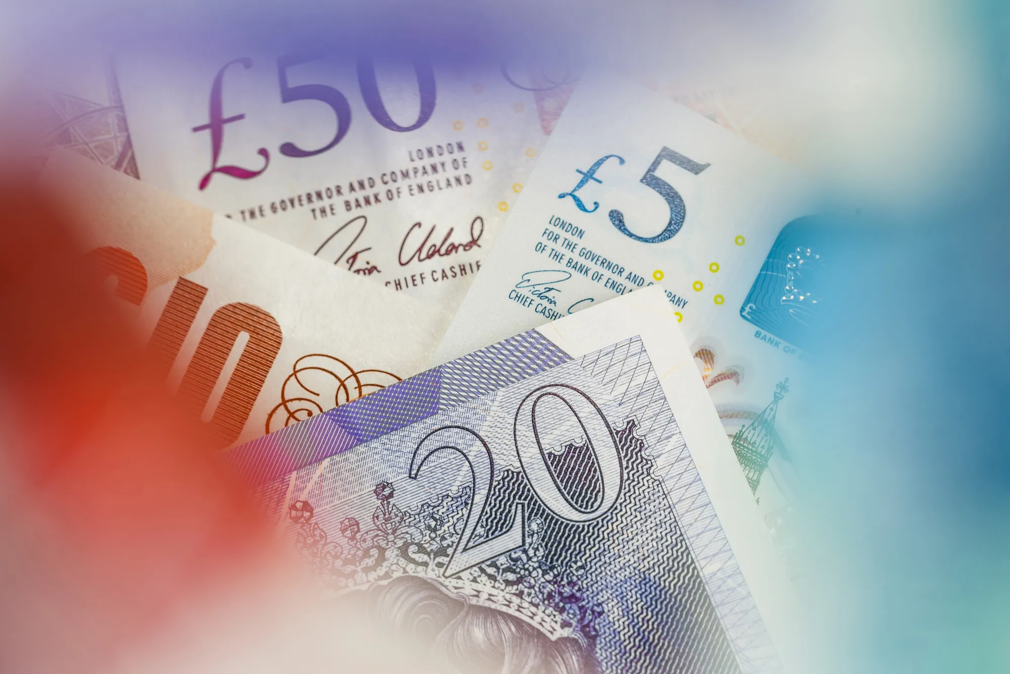 A collection of British pound banknotes.