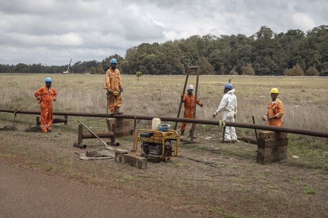 Men work on oil pipeline near Gamba on October 12, 2022.