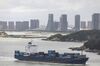 A container ship sails near downtown Xiamen, China, on Monday, Aug. 26, 2019. After a weekend of confusing signals, only a few negotiators in Beijing see a deal possible ahead of the 2020 U.S. election, in part because it’s dangerous to advise President Xi Jinping to sign a deal that Trump may eventually break, according to Chinese officials familiar with the talks who asked not to be identified.