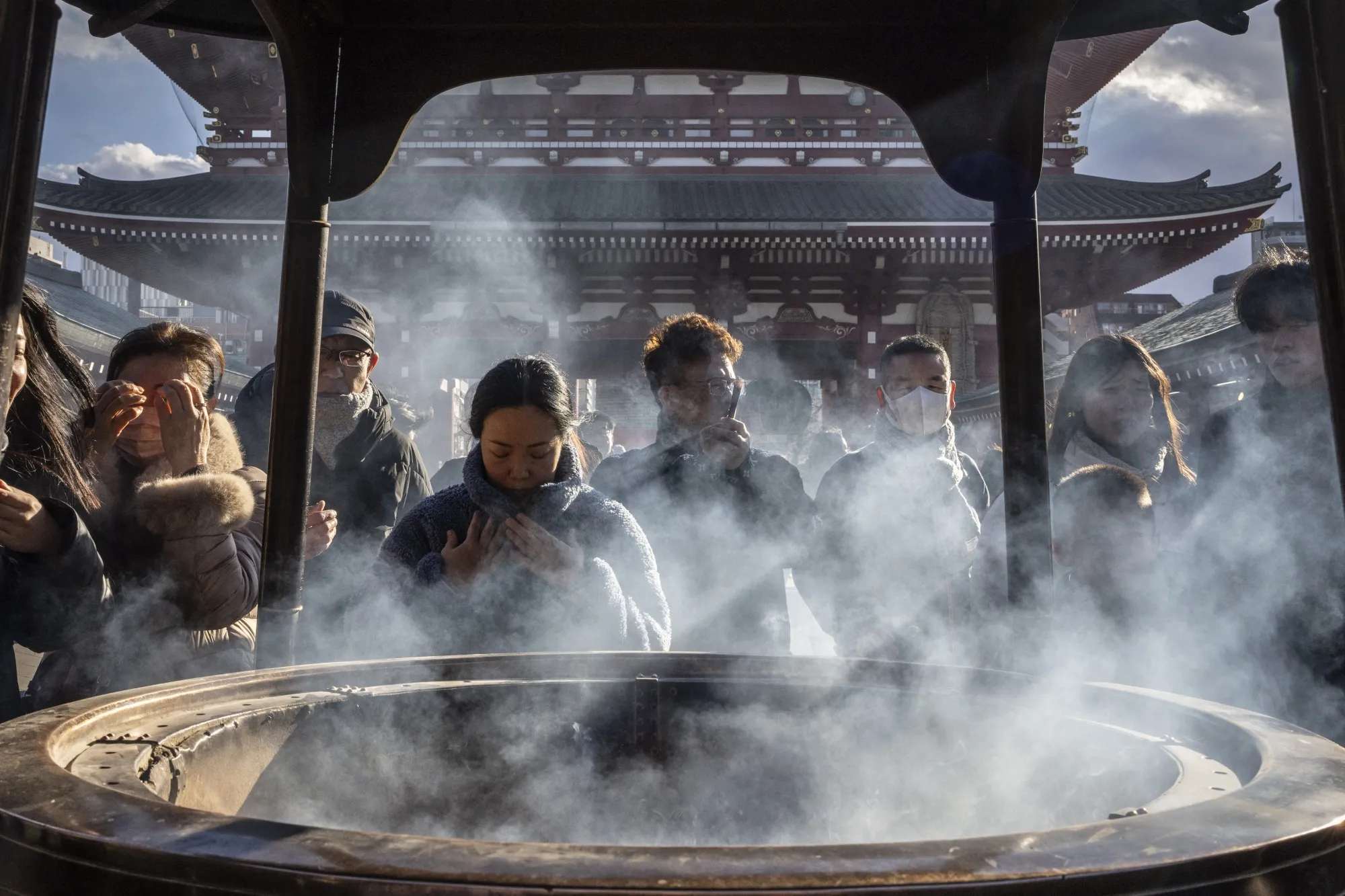 People bathe in incense smoke at Sensoji temple in the Asakusa district in Tokyo on Jan. 8.
