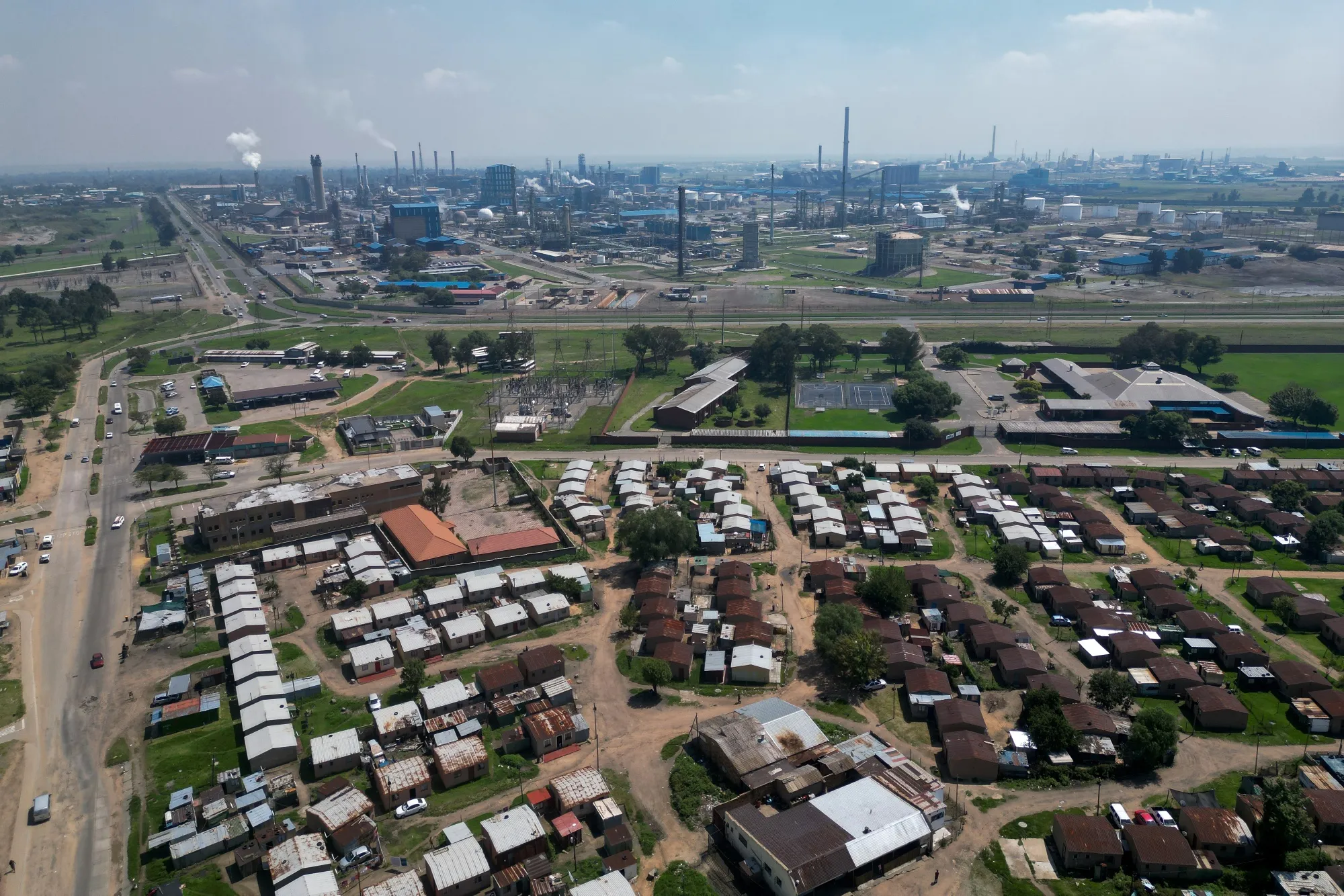 Houses can be seen next to the Sasol Infrachem chemicals processing plant in Sasolburg, South Africa, on Feb.&nbsp;23, 2023.