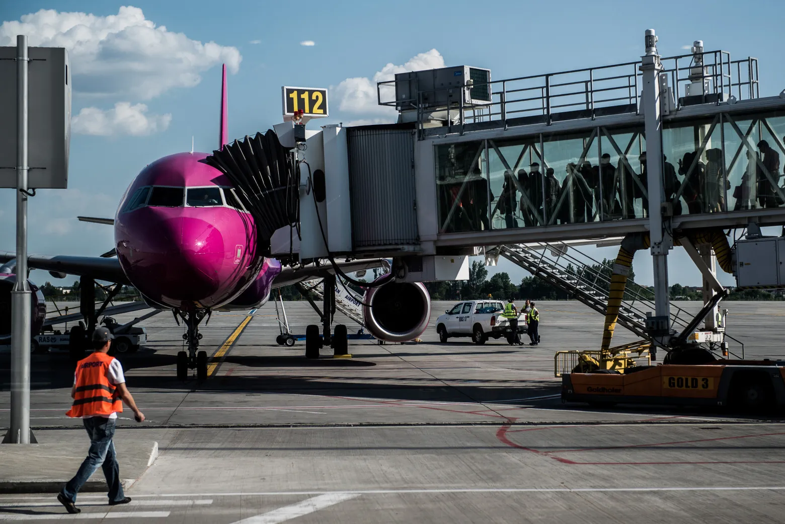 Passengers prepare to board an aircraft at Henri Coanda International airport in Bucharest, Romania.