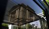 The Bank of Japan headquarters is reflected on a telephone booth window in Tokyo, Japan.