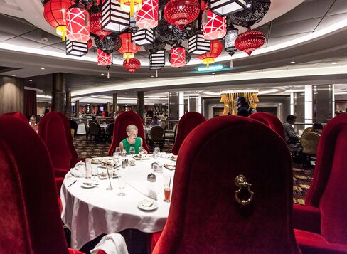 A diner in Harmony of the Seas' main dining room, which is spread over three floors. For drinks later, robot bartenders at the Bionic Bar can shake up custom cocktails.