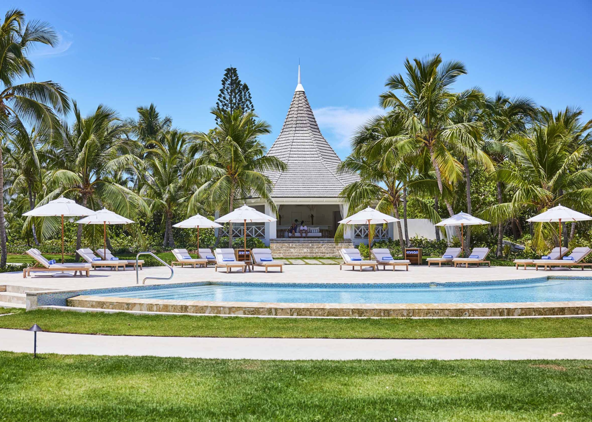 A conical roof stretches above a poolside bar at the Potlach Club hotel.