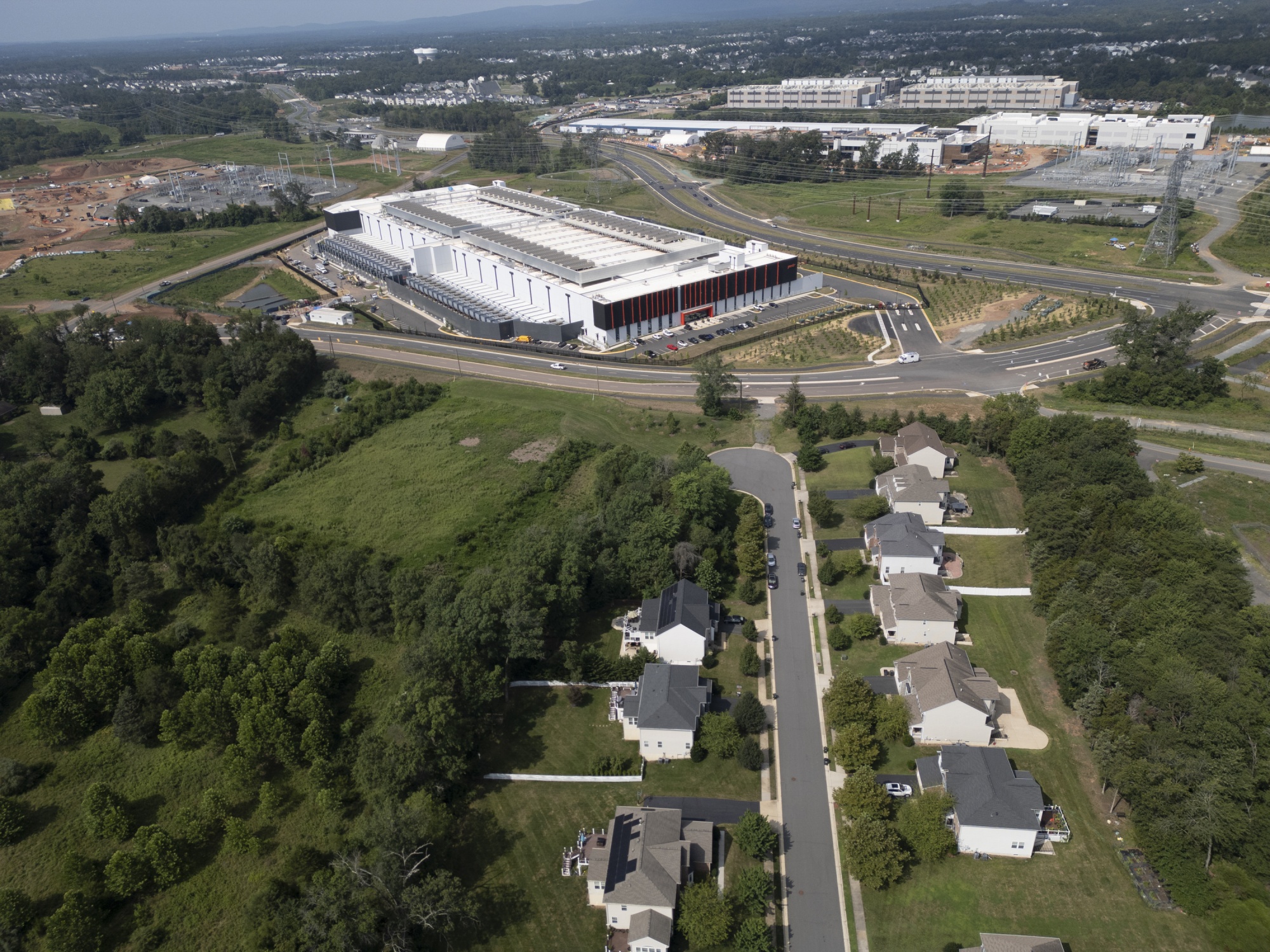 Homes near a data center in Ashburn, Virginia, US, on Friday, July 25, 2025. Northern Virginia housing developments that will soon be walled in by data centers exemplify the tensions over unfettered growth, as calls increase for regulation.