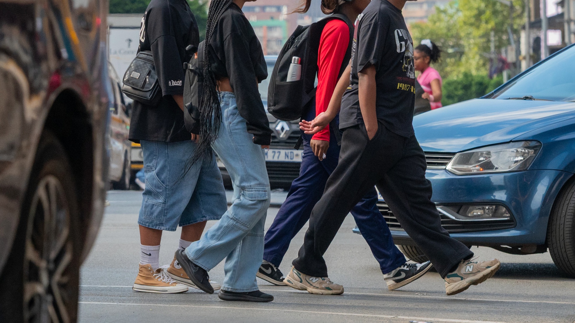 Pedestrians cross a street in the central business district in Johannesburg.