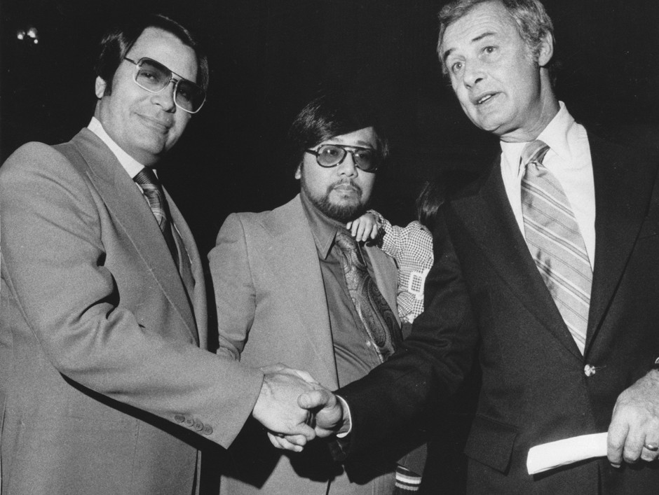 San Francisco Mayor George Moscone, right, shakes hands with Reverend Jim Jones, left, after Jones and Reverend Dr. A. C. Ubalde Jr., center, were sworn to serve on the San Francisco Housing Authority in 1977. 