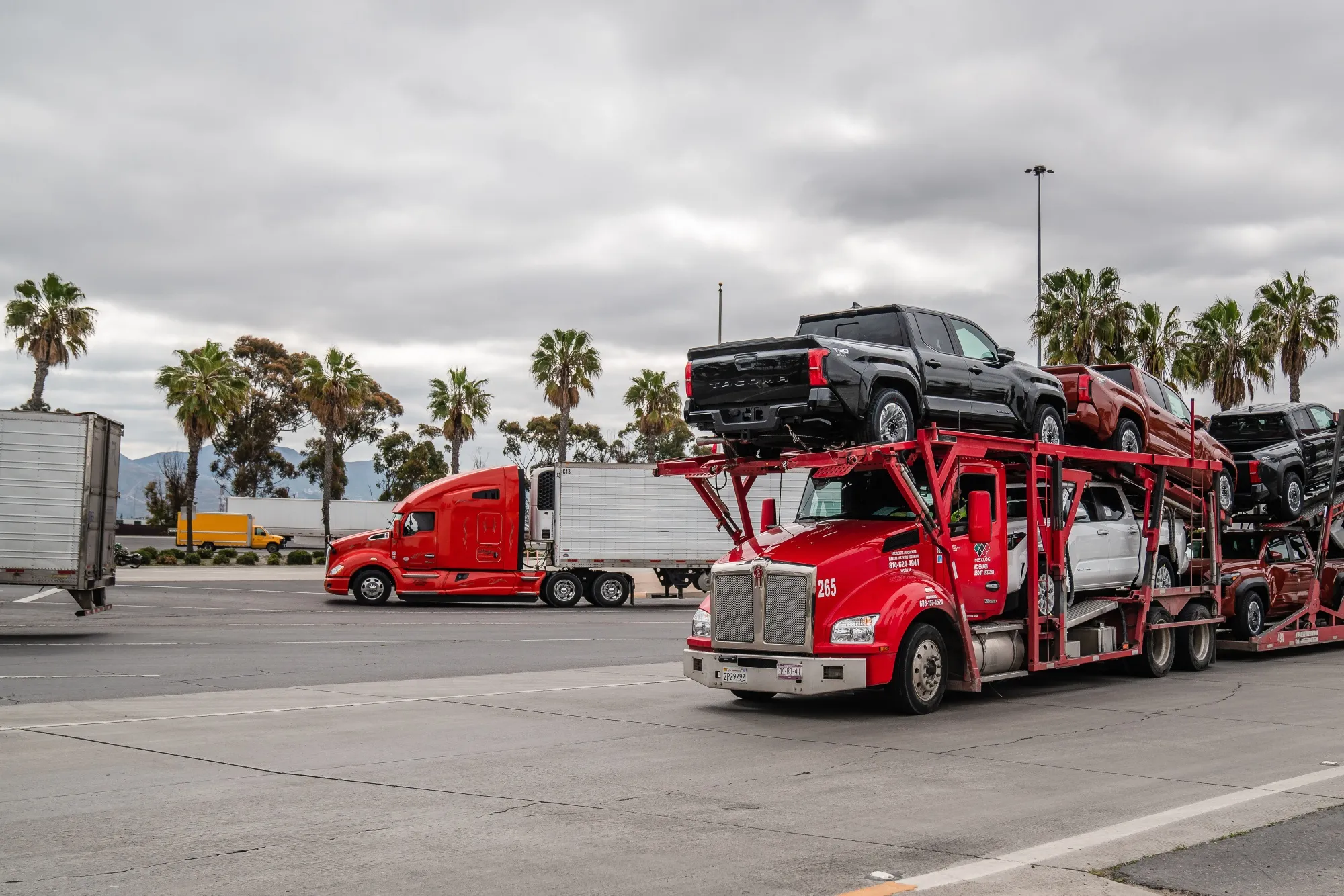 A truck carrying new vehicles, on the US-Mexico border in San Diego, California.