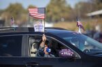 Attendees hold signs during a drive-in rally for 2020 Democratic presidential nominee Joe Biden at the Iowa State Fairgrounds in Des Moines, Iowa, U.S., on Friday, Oct. 30, 2020. 