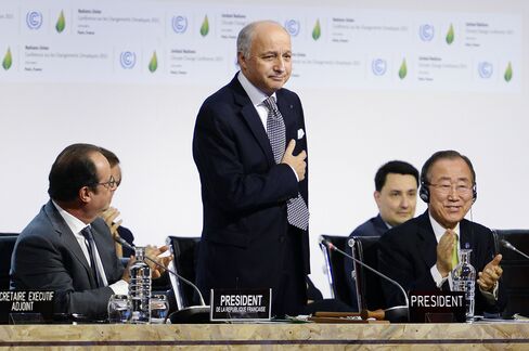 French Foreign Minister Laurent Fabius is applauded Francois Hollande