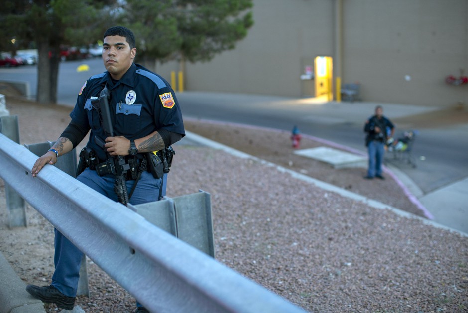 An El Paso Police officer stands guard outside a Walmart store in the aftermath of a deadly shooting in El Paso, Texas.