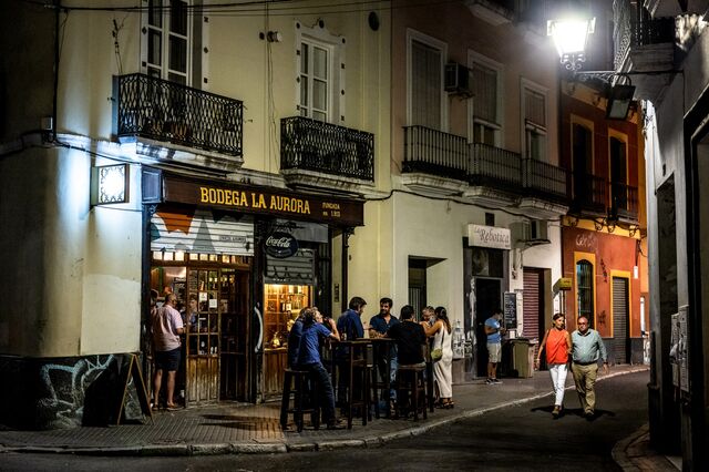 Sevillanos drink cold beer and take walks at night as temperatures become lower.