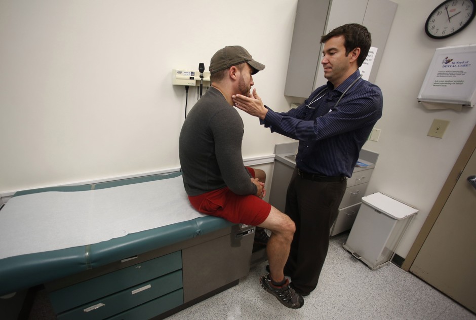 Dr. Raymond Martins, of Whitman-Walker Health in Washington, D.C., examines a patient. 