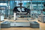 Employees work on a Volkswagen e-Golf electric automobile on the assembly line in Dresden.