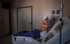 A medical worker wearing personal protective equipment (PPE) takes care of a Covid-19 patient inside the Semi-intensive Care Unit (SCU) at Hospital Sao Paulo in Sao Paulo, Brazil, on Friday, July 24, 2020. Brazil on Tuesday reported almost 68,000 new Covid-19 cases, an all-time high that eclipses the previous record by more than 20% and rivals the numbers seen in the U.S., whose population is 50% bigger.