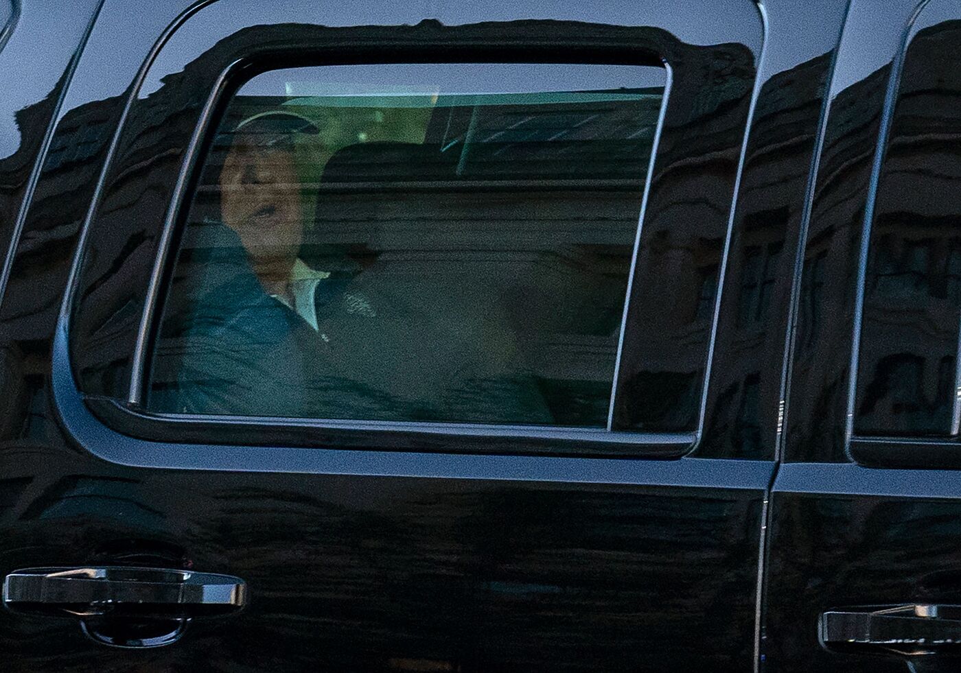 U.S. President Donald Trump watches from the motorcade as he returns to the White House in Washington, D.C., after playing golf on Nov. 7.