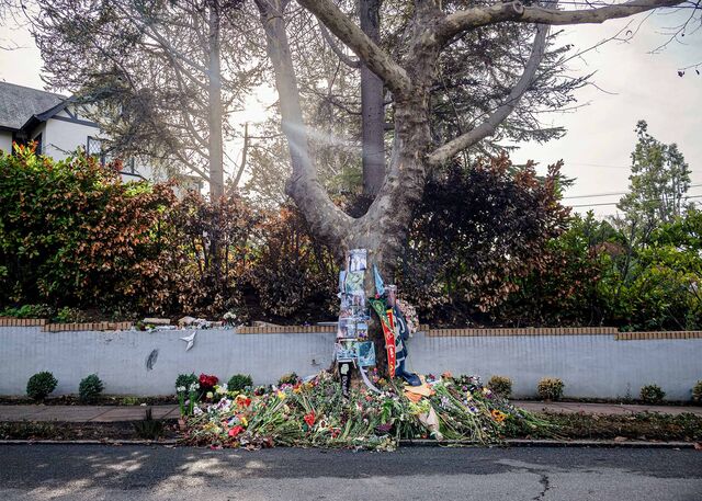 A memorial of flowers and images laid near the tree where three college students died in a Cybertruck crash, in Piedmont, California, US, on Wednesday, Dec. 18, 2024.