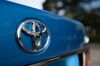 The Toyota Motor Corp. logo is displayed on a Crown vehicle during a test drive in Tokyo, Japan, on Tuesday, Oct. 6, 2015. The Crown sedan will be the first of three Toyota models going on sale in Japan this year that can deliver audio and visual alerts when a driver has taken his or her foot off the brake and has started to creep into an intersection.