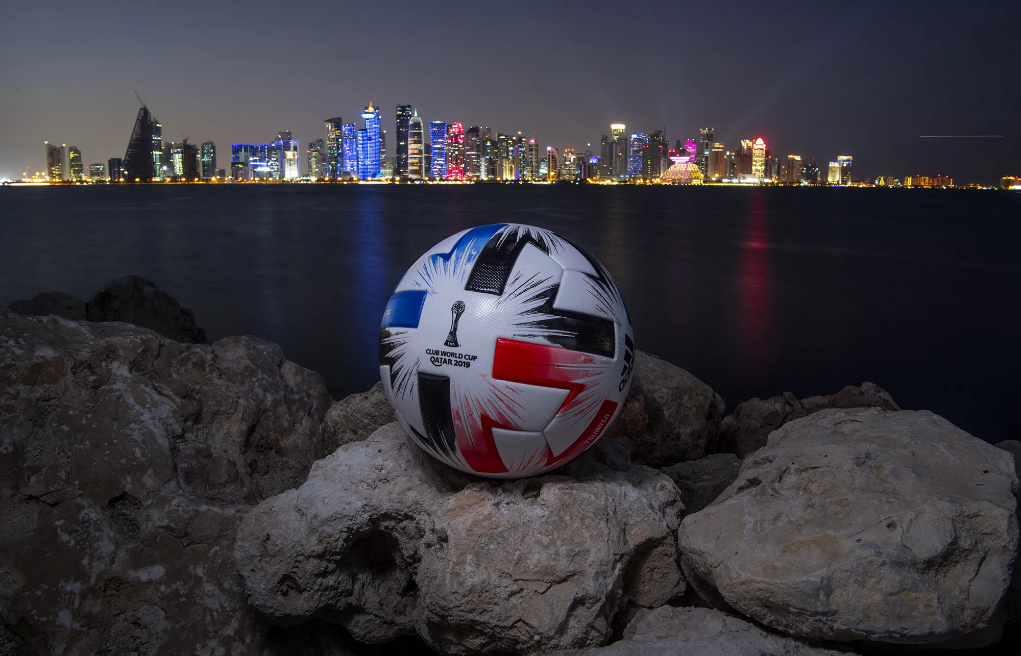 An Official FIFA Club World Cup Qatar 2019 ball sits on display in front of the skyline of Doha
