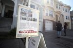 People look at a home for sale during an open house in San Francisco.