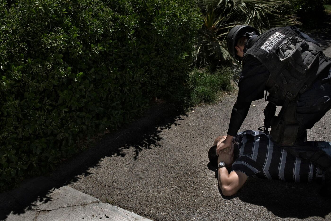 Mexican police detain a suspect in a crackdown on the Juarez Cartel.