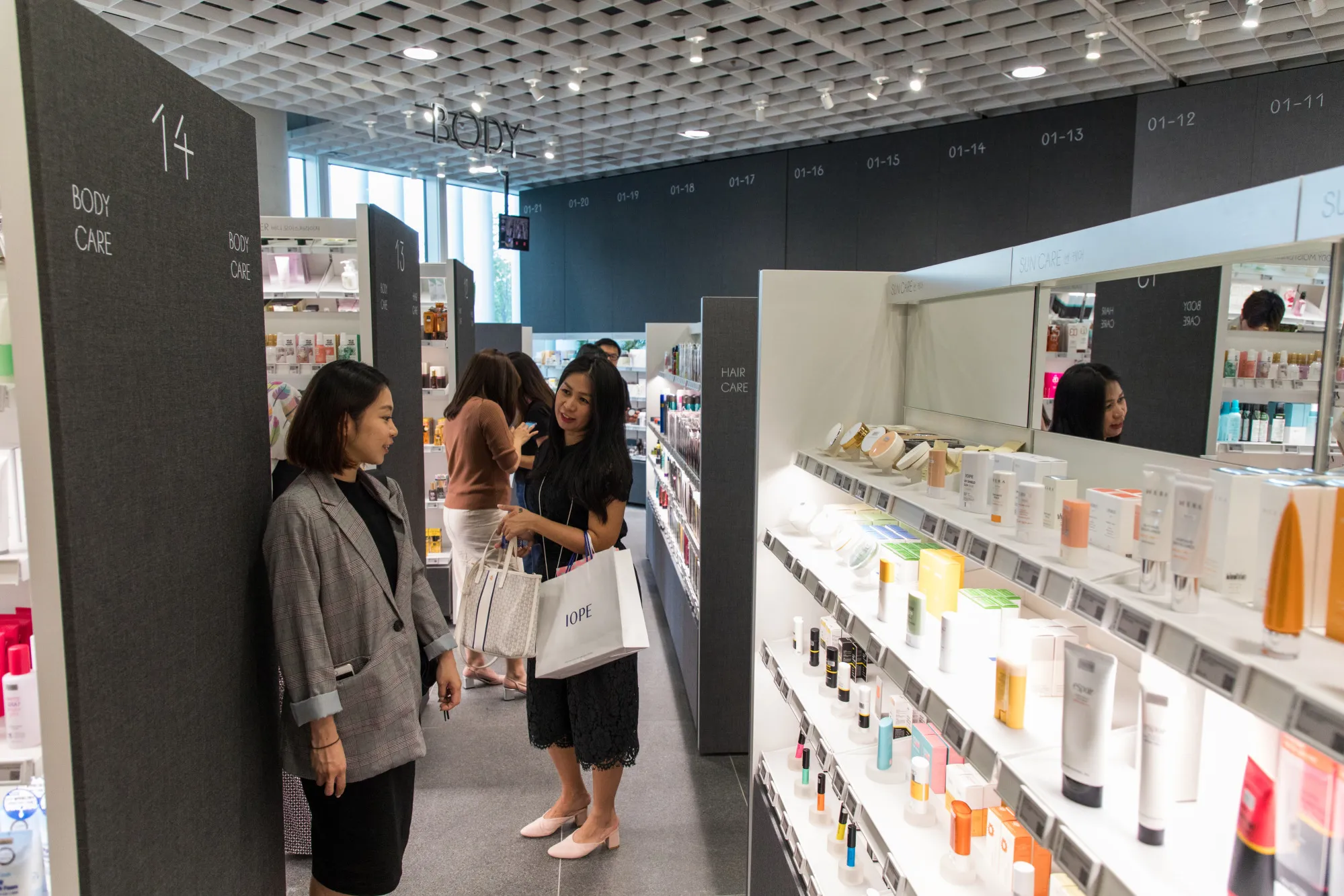 Customers browse Amorepacific&nbsp;cosmetics at the store inside the company's headquarters in Seoul, South Korea.