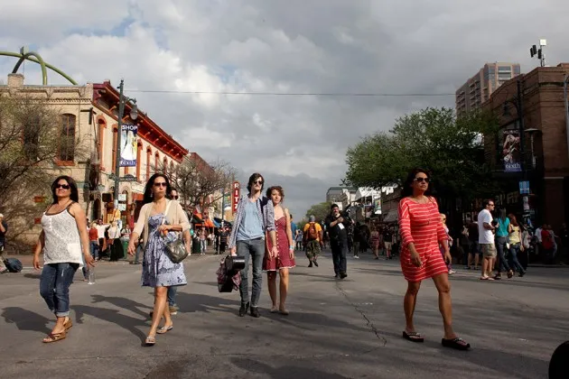 Pedestrians walk around Sixth Street in Austin, Tex., during the 2012 South by Southwest music festival