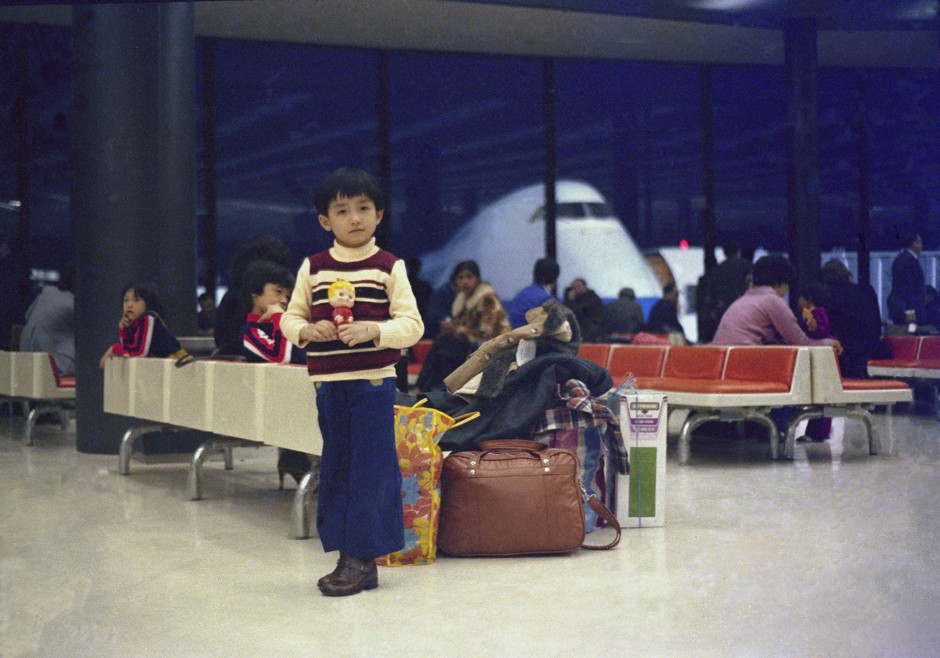 Hon Lu standing in Narita International Airport during a stop-over on the way to Canada, surrounded by the family’s luggage.