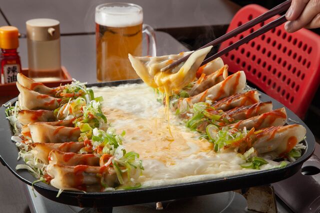 dumplings, melted cheese, beer, scallions in dish