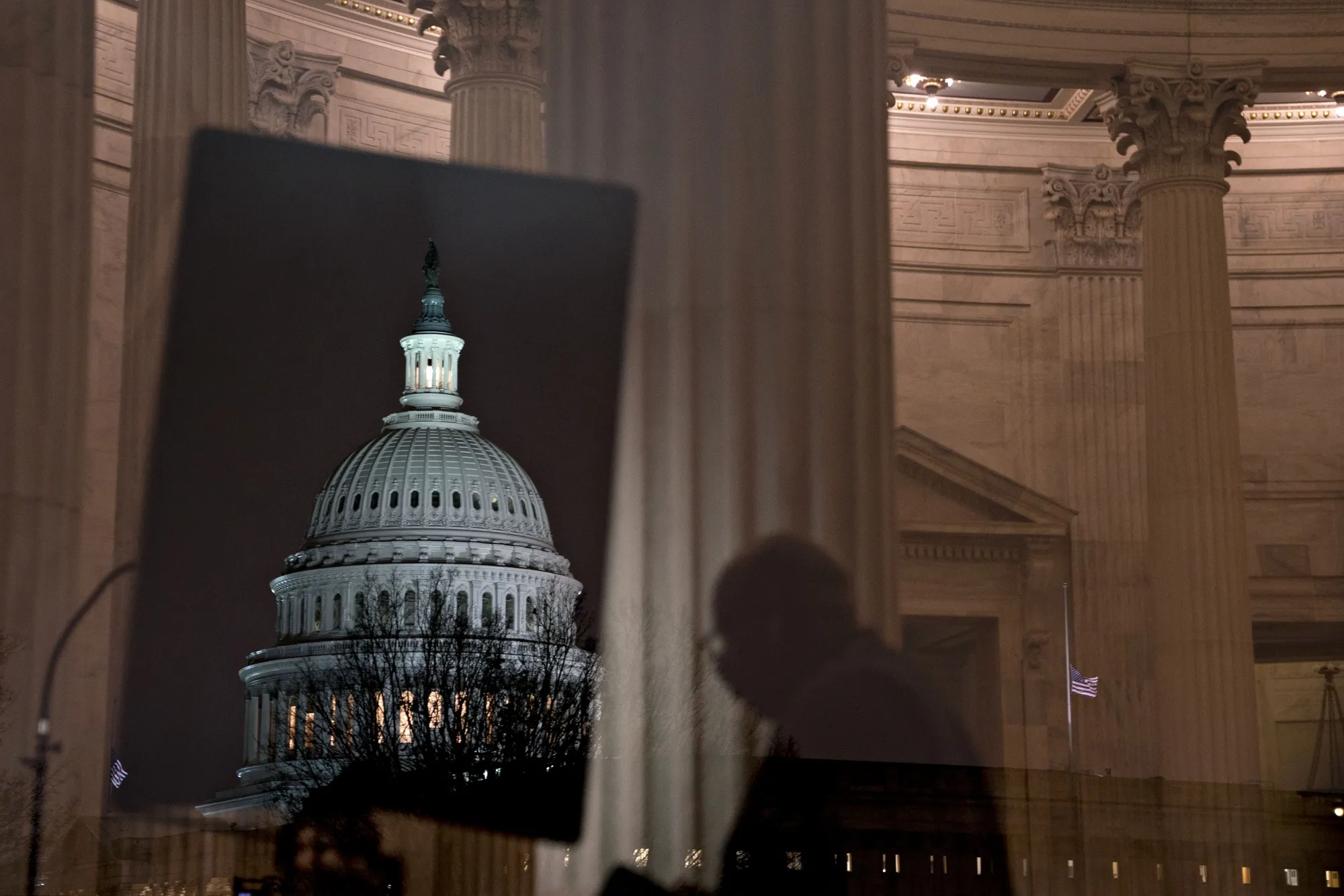 The U.S. Capitol stands past a window of the Russell Senate Office building in Washington, D.C., U.S.