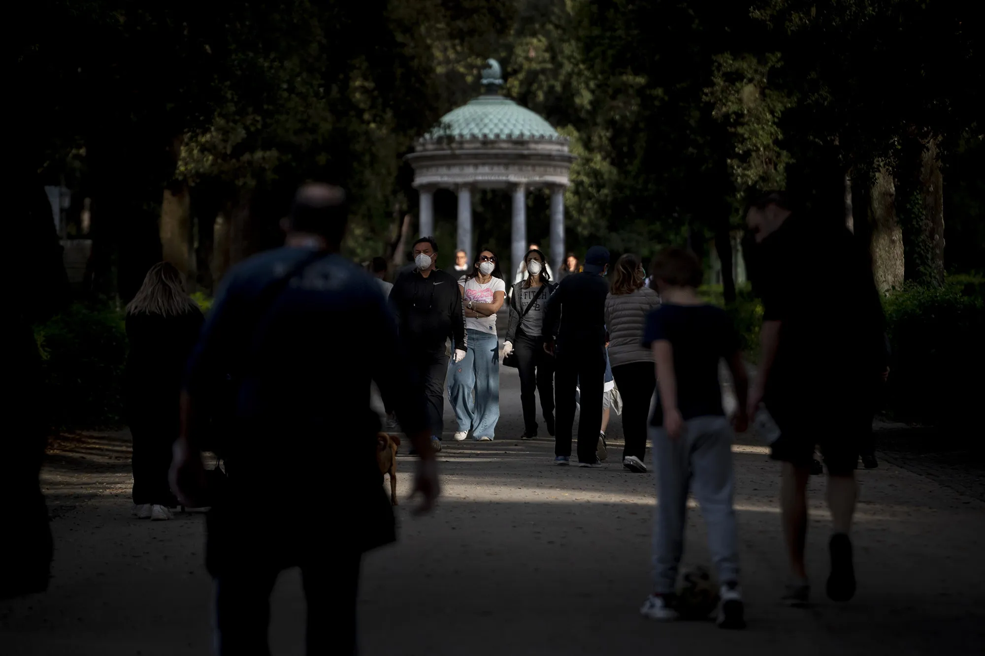 Pedestrians walk through&nbsp;Villa Borghese park in Rome on May 9.